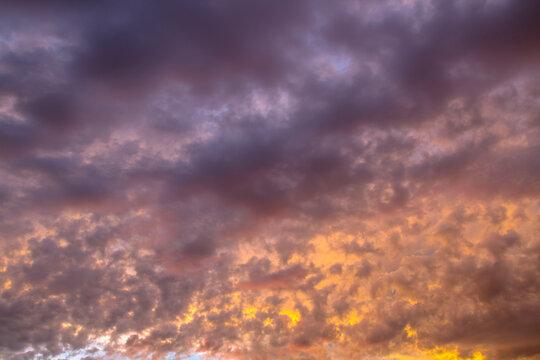 Dramatic beautiful sky background with clouds. Bottom-up view. Nature concept for design or for adding text. Abstract background with a natural sky. Close-up.