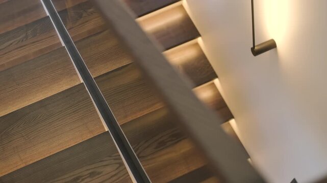 Modern interior design of a wooden staircase with integrated warm LED strip