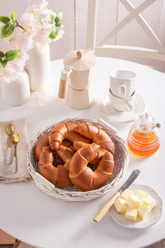 Golden and hot croissants with honey and butter.