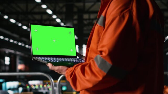 Isolated chroma key, laptop screen, engineer in machinery hall, heavy equipment, metal beams. Factory interior showcasing engineering and industrial framework, and large-scale production.