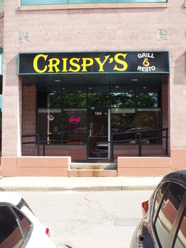 Ottawa, Ontario, Canada-July 16, 2025: The storefront for "CRISPY'S GRILL RESTO" at 2446 Bank Street.