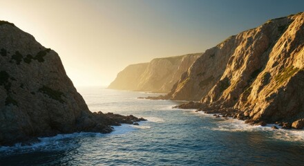 Coastal cliffs frame a shimmering sea under a golden sunset glow