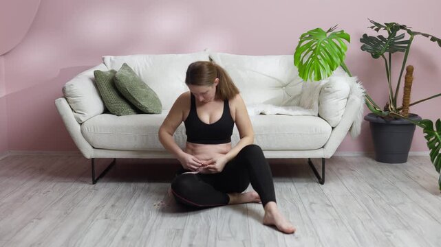 Woman with excess weight unhappy with waist measurement after exercise. Weight loss concept.
