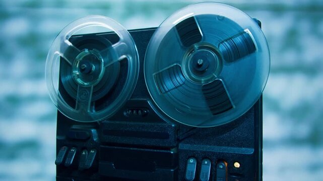 Tape audio music player, VHS studio magnetic tape, vintage retro spool reel to reel player and recorder, magnetic tape data storage close up, music studio. 
