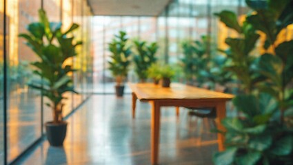 Fototapeta premium Blurred interior design with plants and wooden table in office or restaurant setting with glass walls