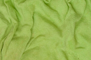 Abstract pattern and texture background of dirty green crumpled t-shirt fabric surface. Copy space...