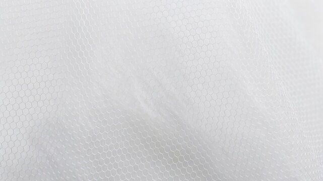 White fabric texture with delicate hexagonal pattern creating a soft transparent background for wedding concepts
