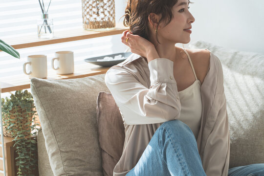 Stylish housewife Asian woman relaxing on the sofa in the living room