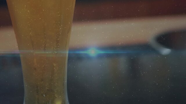 Flare brightening, camera pulling, beer glass lifting, bubbles rising, foam forming to reveal head