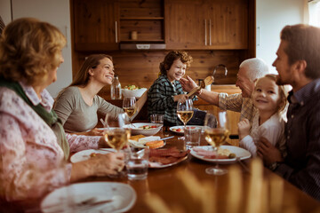 Multigenerational family enjoying dinner at home kitchen