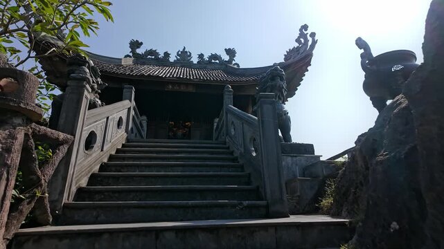 Visitors ascend the stone steps to the  Pagoda, a popular destination for tourists and locals alike in Hoa Lu Old town, Ninh Binh, Vietnam.. The pagoda is a place of worship.