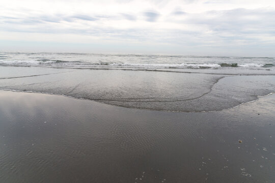 USA, WA, Queets, Olympic National park.  Waves lapping gently on the beach on the west coast of the Olympic Peninsula.  Looking west over the Pacific Ocean.