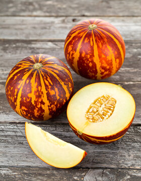 Specialty Cantaloupe Melons Cut Open on Vintage Wooden Table
