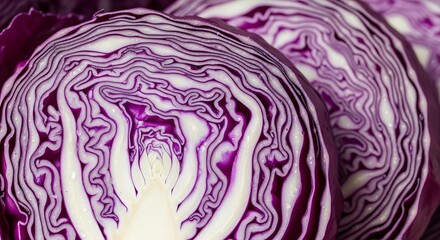 Obraz premium Sliced Red Cabbage: A close-up shot reveals the intricate pattern and vibrant hues of sliced red cabbage, showcasing its natural beauty and culinary potential.