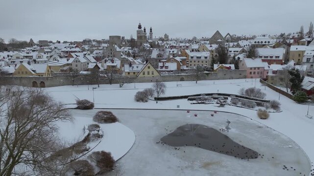 Snow Covered Almedalen Park Transitioning into Visby Old Town Aerial View, Gotland in Winter, Sweden