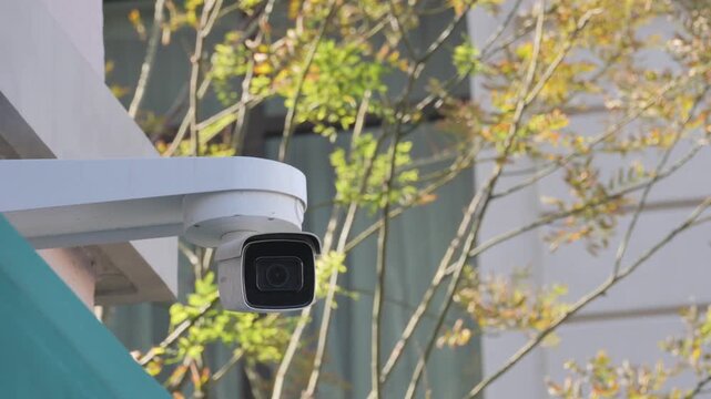 Outdoor security camera mounted on building exterior watching surveillance