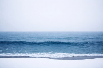 Blue ocean waves rolling onto a sandy beach under a clear sky on a calm summer day