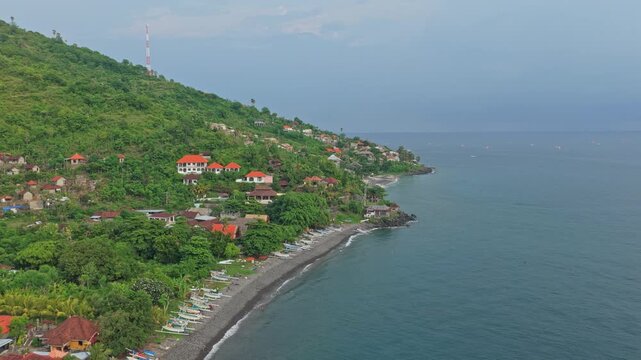 Aerial view of the beautiful amed coast in bali, indonesia. Scenic tropical landscape with a traditional fishing village and boats on the beach