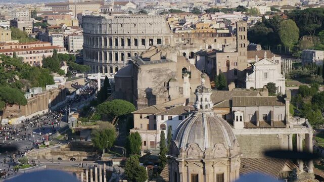 Amazing aerial panorama of Colosseum and Roman forum in Rome with crowd of people on street Via del Fori Imperiali during eastern holidays when street is made to be a pedestrian area