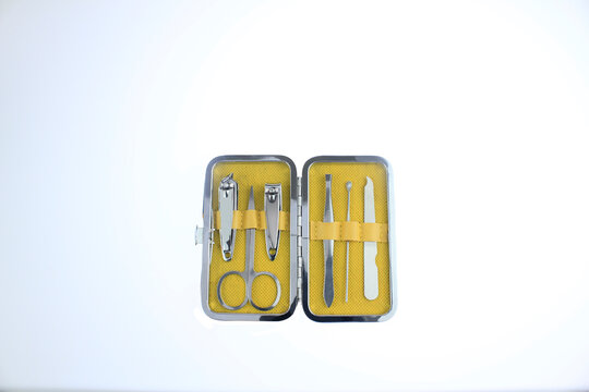 Compact manicure pedicure kit with nail clippers, scissors and tweezers in travel case isolated on white background. Personal grooming, nail care tools for hygiene, beauty treatment, daily self  care 
