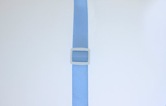 blue adjustable strap with plastic buckle isolated on white background. Equipment fastening strap used for luggage, outdoor gear, adjustable attachments, equipment fastening, for drinking bottle parts