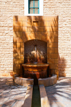 Traditional water fountain and palm grove at the historic Murabba Palace of Riyadh, Saudi Arabia