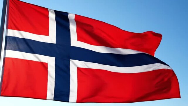 The Norwegian flag waving in the wind against a clear blue sky from a frontal viewpoint