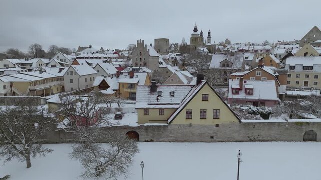 Winter Drone Tracking Along Snow-Covered Visby City Wall from Almedalen Park, Winter on Gotland, Sweden