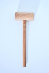 Simple small wooden hammer tool isolated on vertical white background from top angle view.
