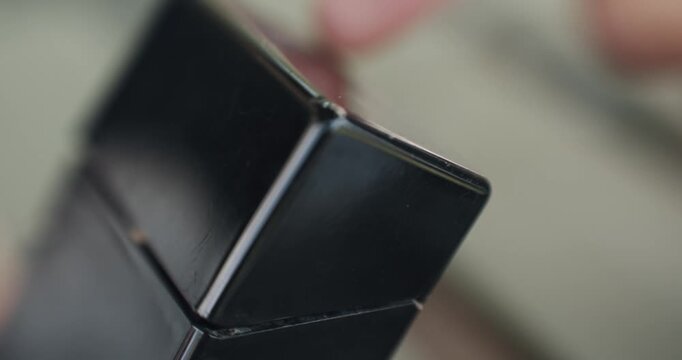 Hand opening cigarette pack box in slow motion with selective focus, cinematic shot