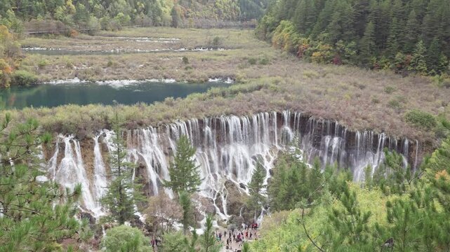 High angle view of Nuorilang Falls or Nuorilang waterfall. Beautiful landscape of Jiuzhaigou National Park in autumn in Sichuan Province China. 4K slow motion footage travel concept.