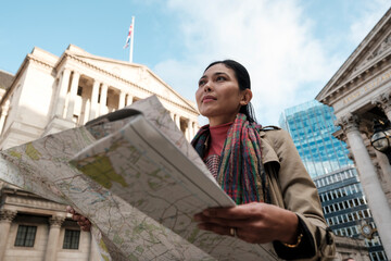 Woman tourist holding map discovering city of london