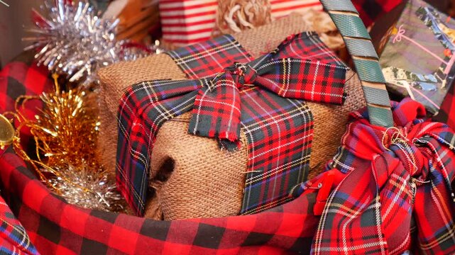 Holiday gifts wrapped in plaid patterns at festive location