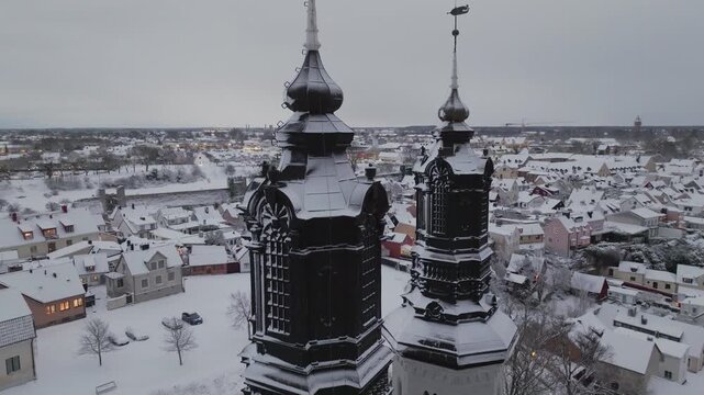 Ascending Aerial Shot of Visby Cathedral (Domkyrka) Snow-covered Towers, Winter on Gotland, Sweden