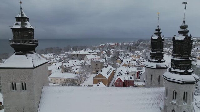 Winter Drone Pass Between Visby Cathedral Towers Over Old Town of Visby, Gotland