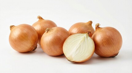 A close-up view of several whole yellow onions with one cut in half to reveal its layers