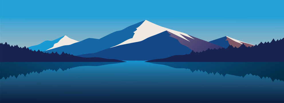 mountain range beside a peaceful lake bordered by dense