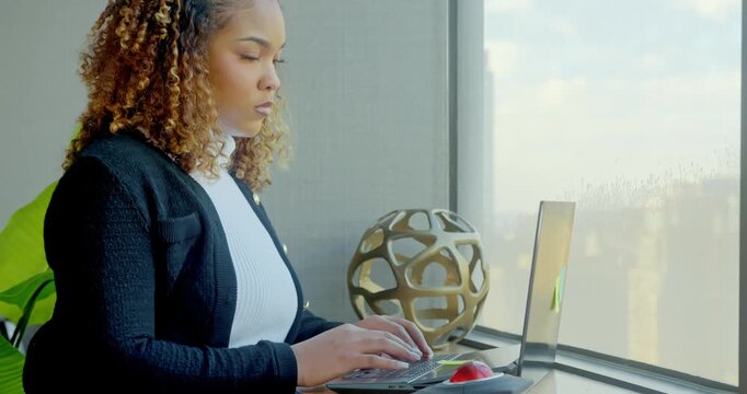 Focused Woman Typing in Modern Office