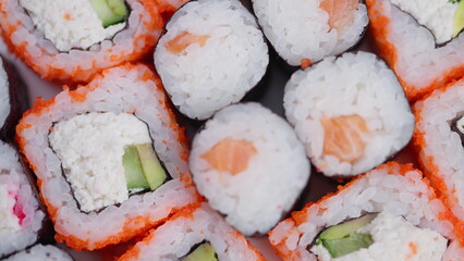 Appealing presentation of seafood sushi. Visually tempting arrangement of fresh sushi items. Stunning and enticing presentation of various colorful and fresh sushi pieces © beholdereye