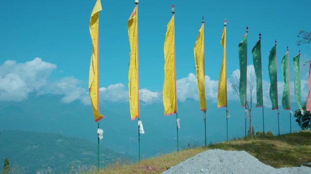 Colorful Tibetan Prayer Flag Waving in the Wind Over Himalayan Mountains