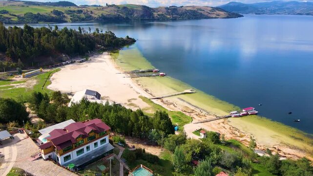 Stunning aerial snapshot of Tota Lagoon showing greenish waters and sandy beaches, with boats docked along the shore.