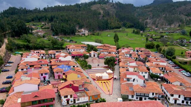 A scenic aerial view showing vibrant roofs of houses and a central plaza in Duitama, Boyac&aacute; on an overcast day.