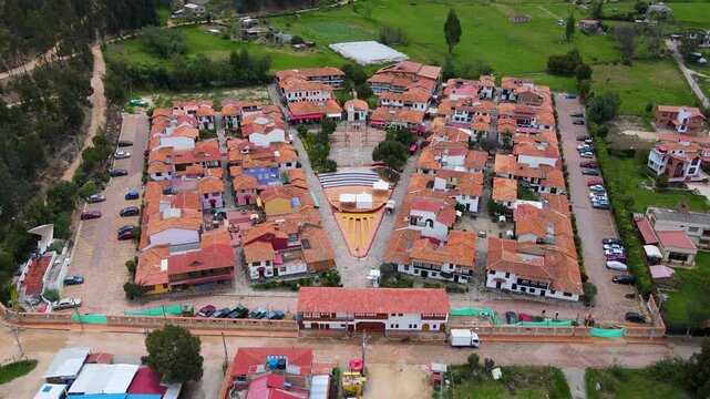 This aerial shot captures colorful rooftops and well-maintained green areas in Duitama, showcasing the picturesque layout of the town.