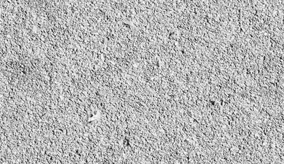 Obraz premium Close-up texture of coarse grey gravel surface with shadows and highlights, abstract background, stock media