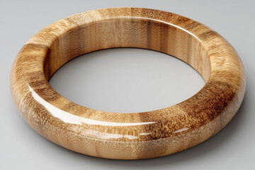Smooth polished wooden ring with glossy finish on gray surface
