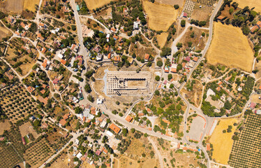 Naklejka premium Didim, Turkey. Abstract geometric pattern from above showing ancient temple ruins contrast with organized farmland and urban structures. Aerial view