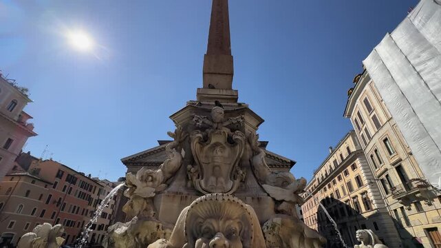 Fountin at Piazza della Rotonda with obelisk and ancient roman Pantheon temple with surrounding historic rome buildings at sunny day, slow motion