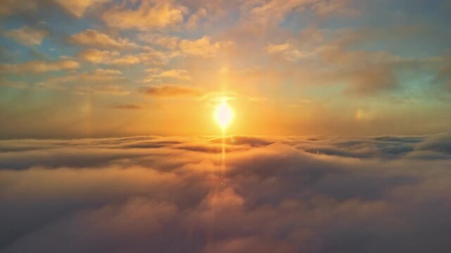 A bright yellow sun shines in a blue sky above the dark gray cloud cover.