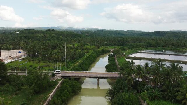 Drone Forward Flight Over Tapon Bridge River And Aquaculture Ponds Cebu