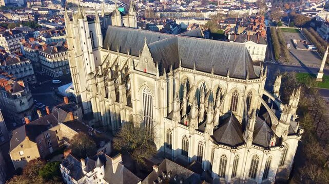 Drone view of Cathedral of St Pierre and St Paul overlooking the public square Place Mar&eacute;chal Foch with its monument in Nantes, France. Aerial drone backward
